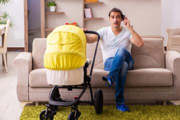 Young male contractor looking after new born at home
