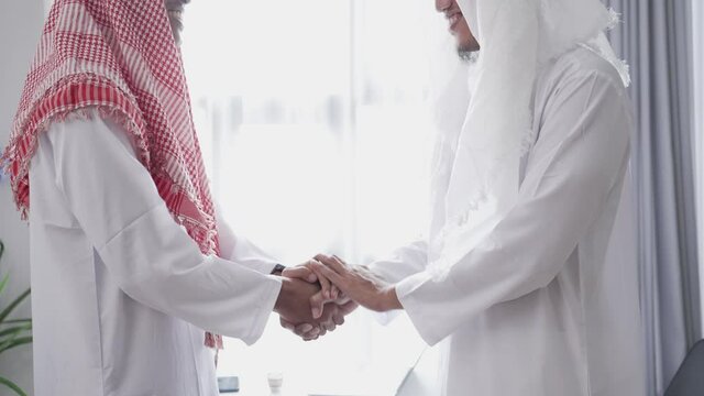 portrait of business muslim partner shaking hand in the meeting