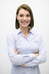 Portrati shot of beautiful blond businesswoman standing with arms crossed at isolated white background.