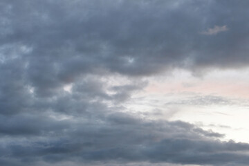 Dark gloomy gray cloudy sky before thunderstorm in summer. Storm heaven, gloomy backdrop.