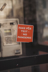 Fake PCR test - No Pandemic sticker on the Phone booth in central part odf the city