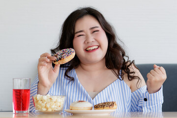 Happiness closeup shot of Asian young happy beautiful hungry overweight fat chubby female smile at...