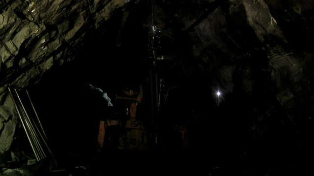 Underground Mining, Mine Worker looking at Rock Drilling Machine inside a Coal Mine, Rio Turbio, Santa Cruz Province, Argentina.