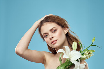 Attractive Lady white flowers blue background portrait cropped view