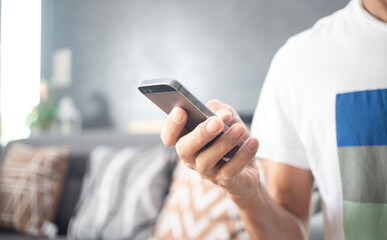Hand of person working with mobile phone during stay at home, communication concept