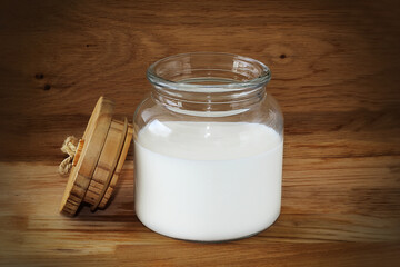 Glass jar with milk. Milk - main product of the Jewish holiday Shavuot. Concept: Shavuot holiday traditions, Israel