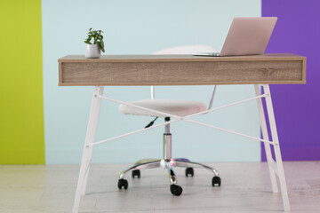 home office concept. chair, laptop, desk and flowers.