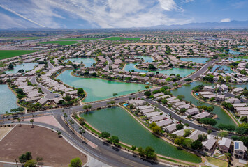 Aerial roofs of the many small ponds near a Avondale town houses in the urban landscape of a small sleeping area Phoenix Arizona US