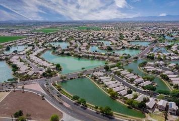 Rolgordijnen Aerial roofs of the many small ponds near a Avondale town houses in the urban landscape of a small sleeping area Phoenix Arizona US © ungvar