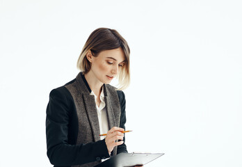 Woman in a suit In a bright room with documents in hands cropped view