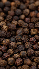 black pepper top view. Flavorful and aromatic peppercorn. Pile of dried black peppercorns