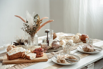 Easter table setting with decor details and homemade cakes.