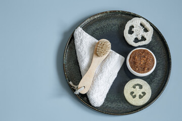 Spa composition with massage brush, scrub, loofah and towel.