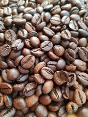 Brown coffee beans lie on a plate