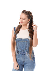 Beautiful young woman with braided hair on white background