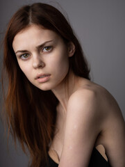 Obraz premium Pretty woman model red hair bared shoulders close-up cropped view