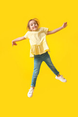 Fototapeta na wymiar Jumping little girl on color background