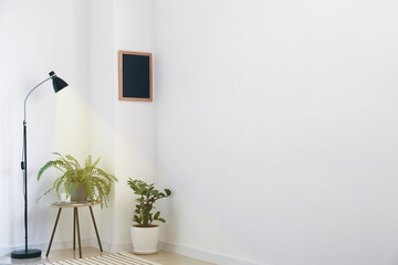 Interior of modern room with lamp and houseplants