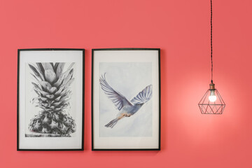 Glowing lamp with pictures on color background