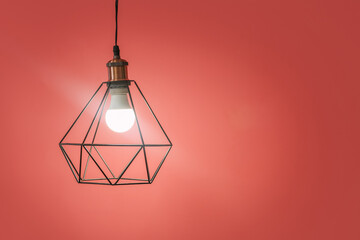 Glowing lamp on color background, closeup