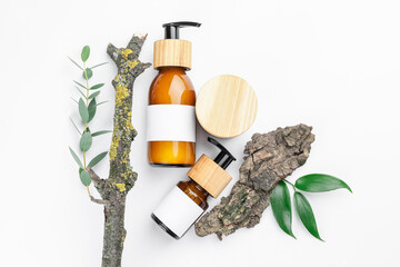 Bottles with natural shampoo on white background