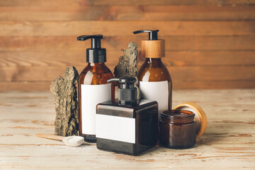 Obraz na płótnie Canvas Bottles with natural shampoo on wooden background