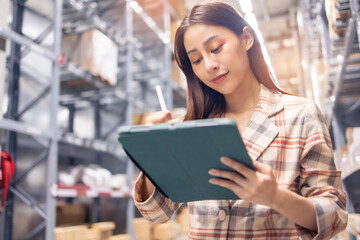 Portrait of smiling asian manager worker woman standing and order details on tablet computer for checking goods  in warehouse store .Asian owner or small business concept.