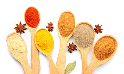 Spoons with different spices on white background