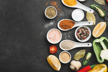 Different spices and vegetables on dark background