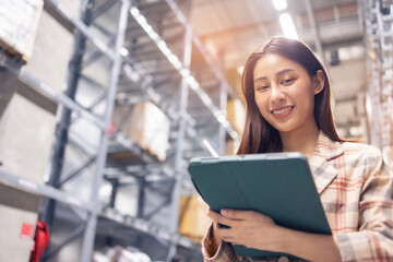 Portrait of smiling asian manager worker woman standing and order details on tablet computer for checking goods  in warehouse store .Asian owner or small business concept.