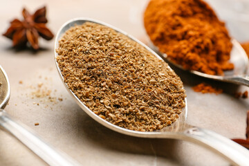 Spoon with pepper powder on grunge background, closeup