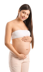 Young pregnant woman on white background