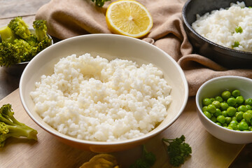Plate with tasty rice on wooden background