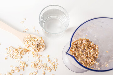 Step by step recipe. Cooking oat vegetable milk. Step 2 pour oatmeal with water in blender. Homemade food concept. Plant based organic veggie milk, lactose free