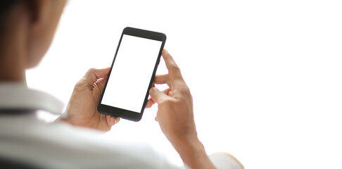 Man hands holding smart phone with blank copy space screen for your text message or information content, female reading text message on cell telephone during in urban setting.