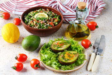 Egg baked in avocado with green salad