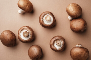 Whole royal brown champignons on brown background. View from above.