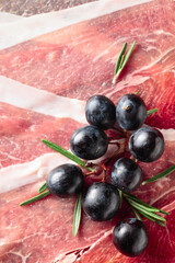 Prosciutto with grapes and rosemary.