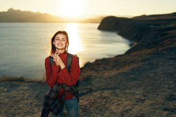 cheerful woman tourist with backpack travel freedom walk landscape