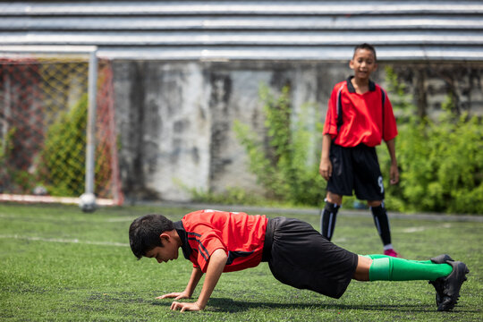 Friend boy teens push up push-ups workout in a grass.