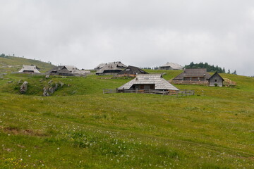 Fototapeta na wymiar Old village of Velika Planina, slovenia. Traditional cattle town in high mountain meadows of Julian Alps