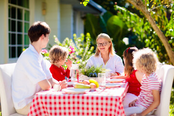 Family eating outdoor. Garden summer fun.