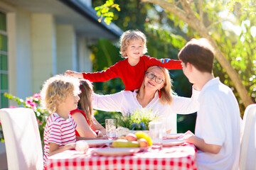 Family eating outdoor. Garden summer fun.