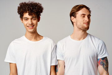 two men in white t-shirts are standing next to friendship emotions