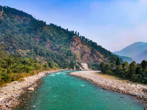 river flowing with mountain background