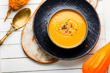 Tasty pumpkin creamy soup in bowl