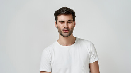 Young bearded man wearing t-shirt winking
