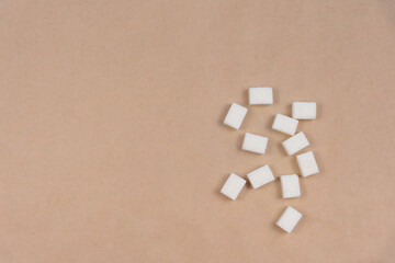 Several pieces of white sugar on craft paper