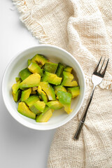 Fresh sliced avocado in white bowl