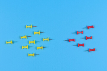 Several push pins are placed opposite each other.